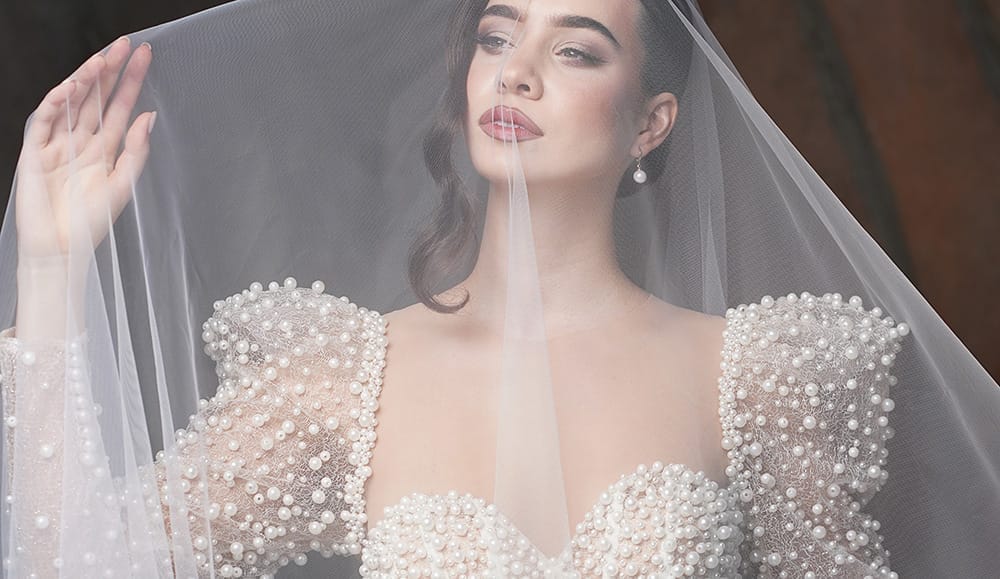 Bride wearing a cathedral-length wedding veil, perfect for a formal ceremony.